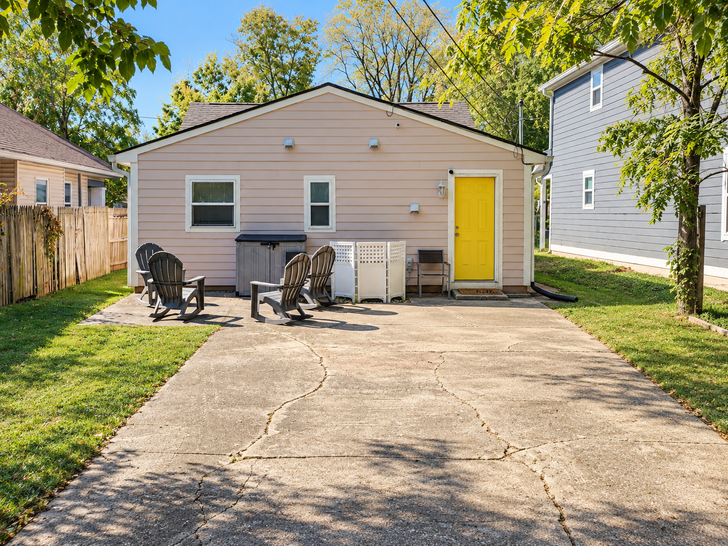Columbia Urban Oasis rear exterior with yellow entry door, patio chairs and driveway