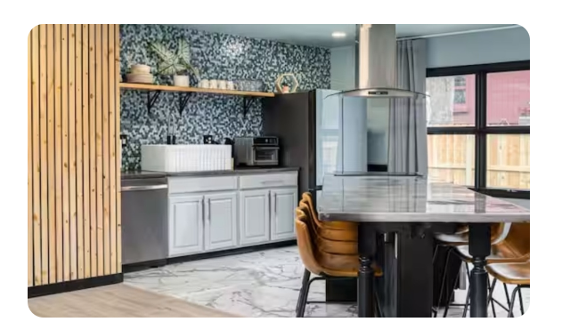 5850 Devington kitchen with wood slat wall, backsplash, white cabinets and black island