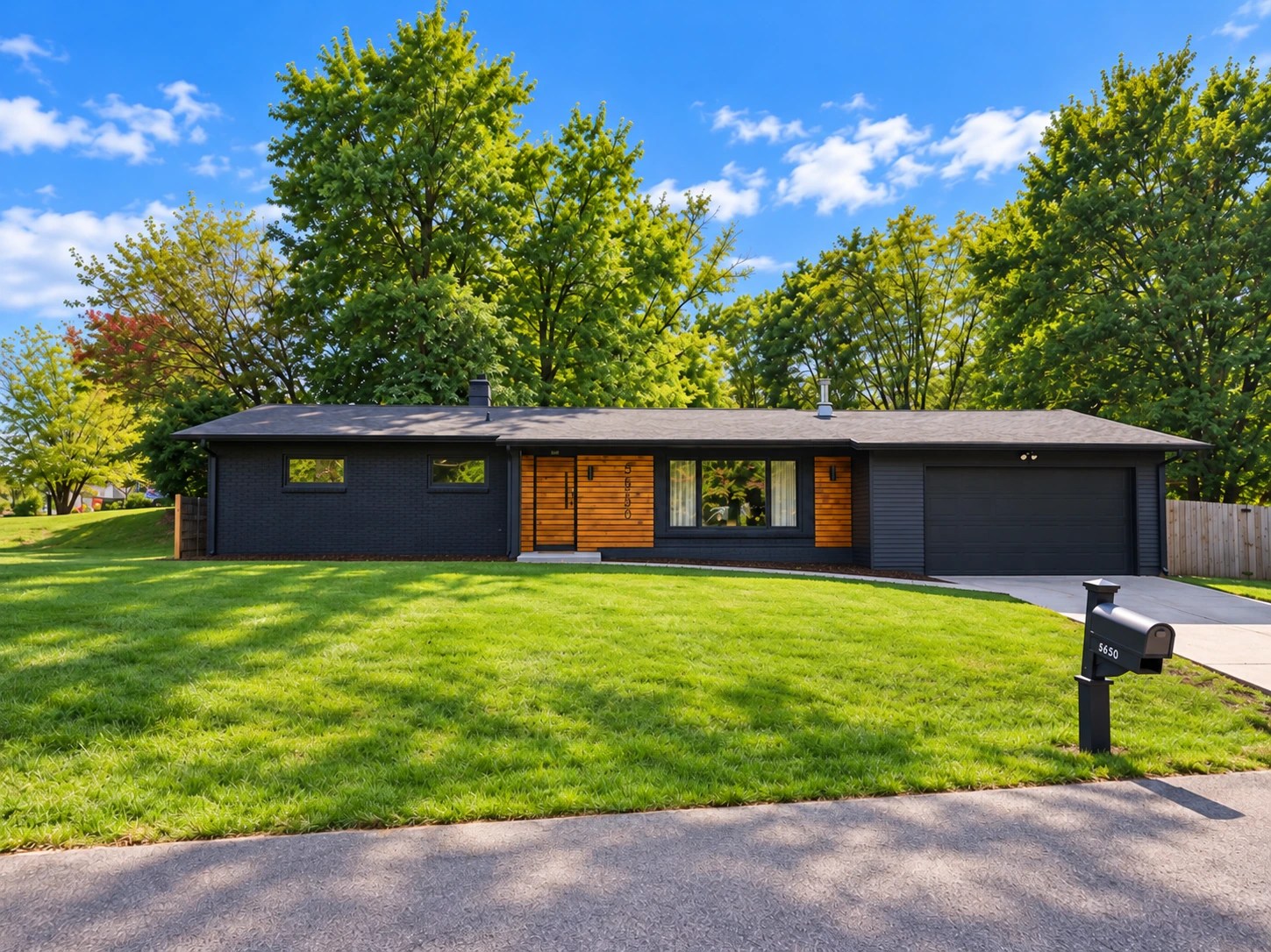 5850 Devington charcoal ranch exterior with wood accents, natural lawn, and empty driveway