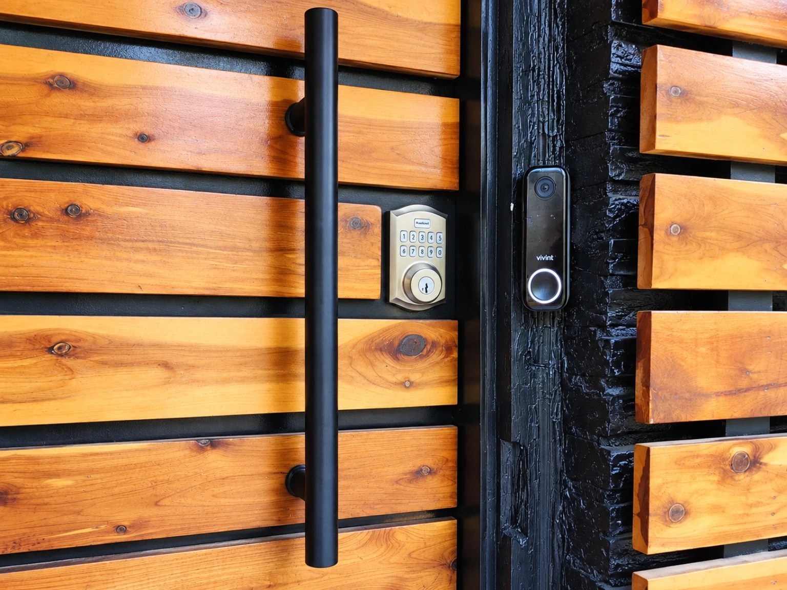 Actual front door with keypad smart lock and Vivint doorbell, uncropped composition